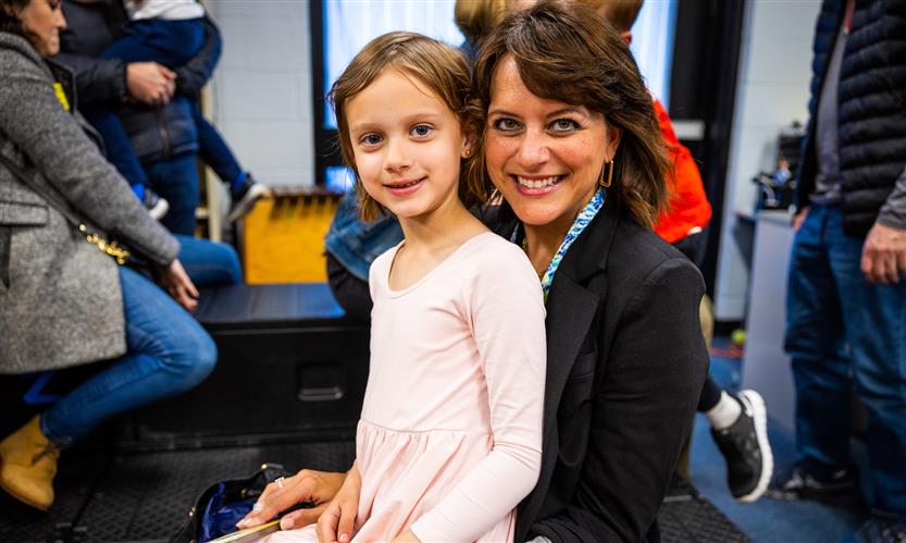A mother smiles with her daughter